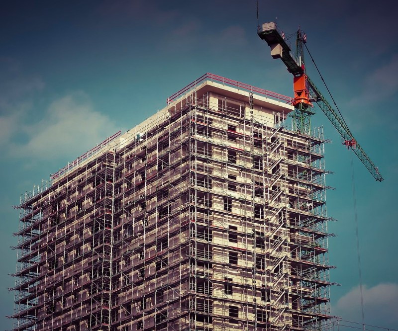 home builders federation image with large building covered in scaffolding with crane on top