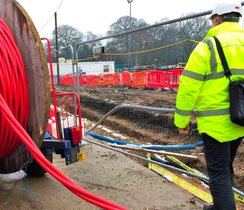 work survey showing man in hi vis walking alongside utility works